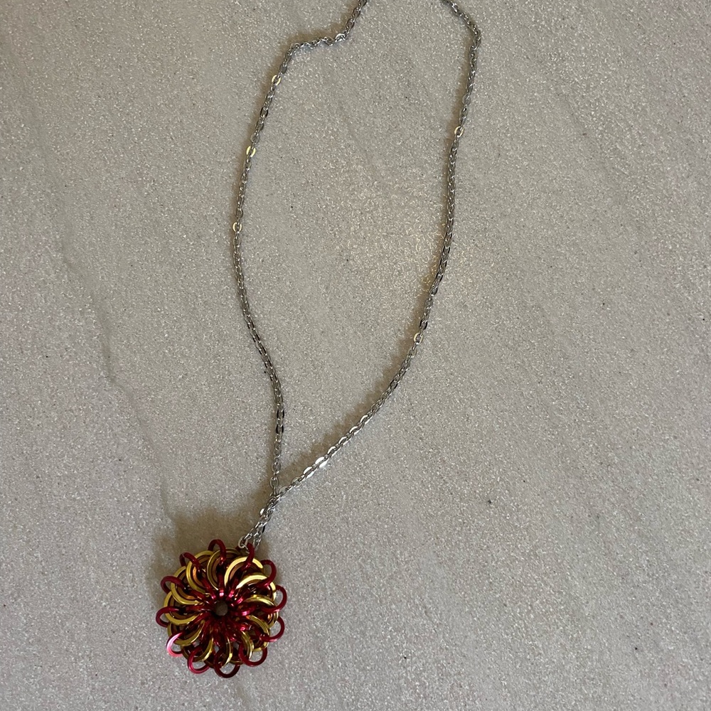 Elegant Red and Gold toned Pendant Necklace. Approximately 19”